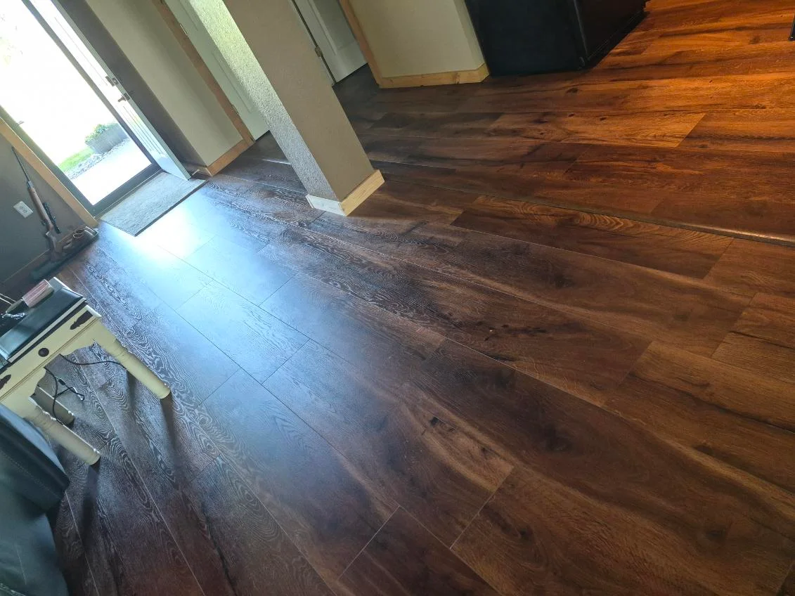 Newly installed hardwood flooring with warm medium-brown tone and natural wood grain patterns