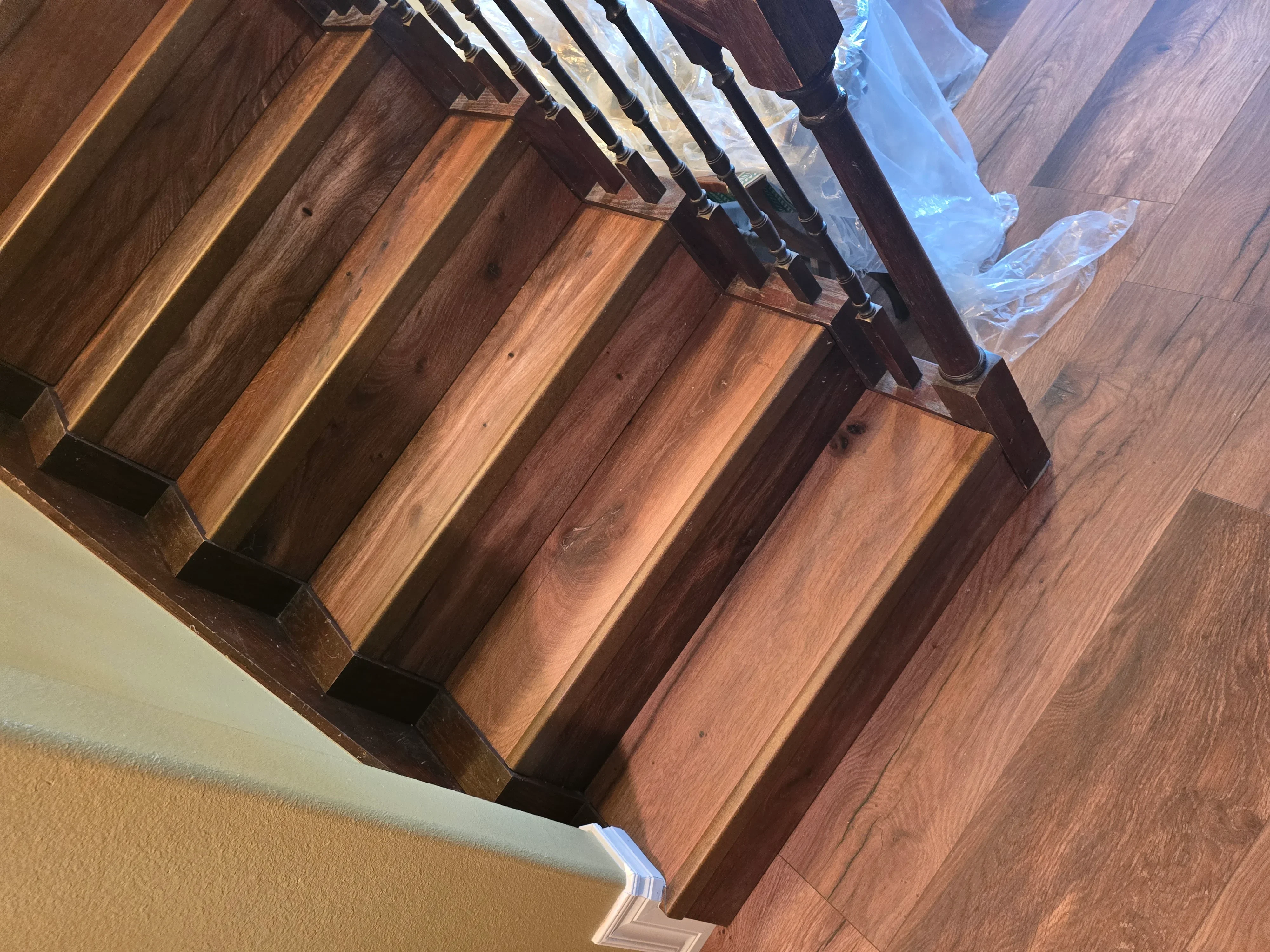 Newly installed hardwood flooring with warm walnut tones and straight plank layout